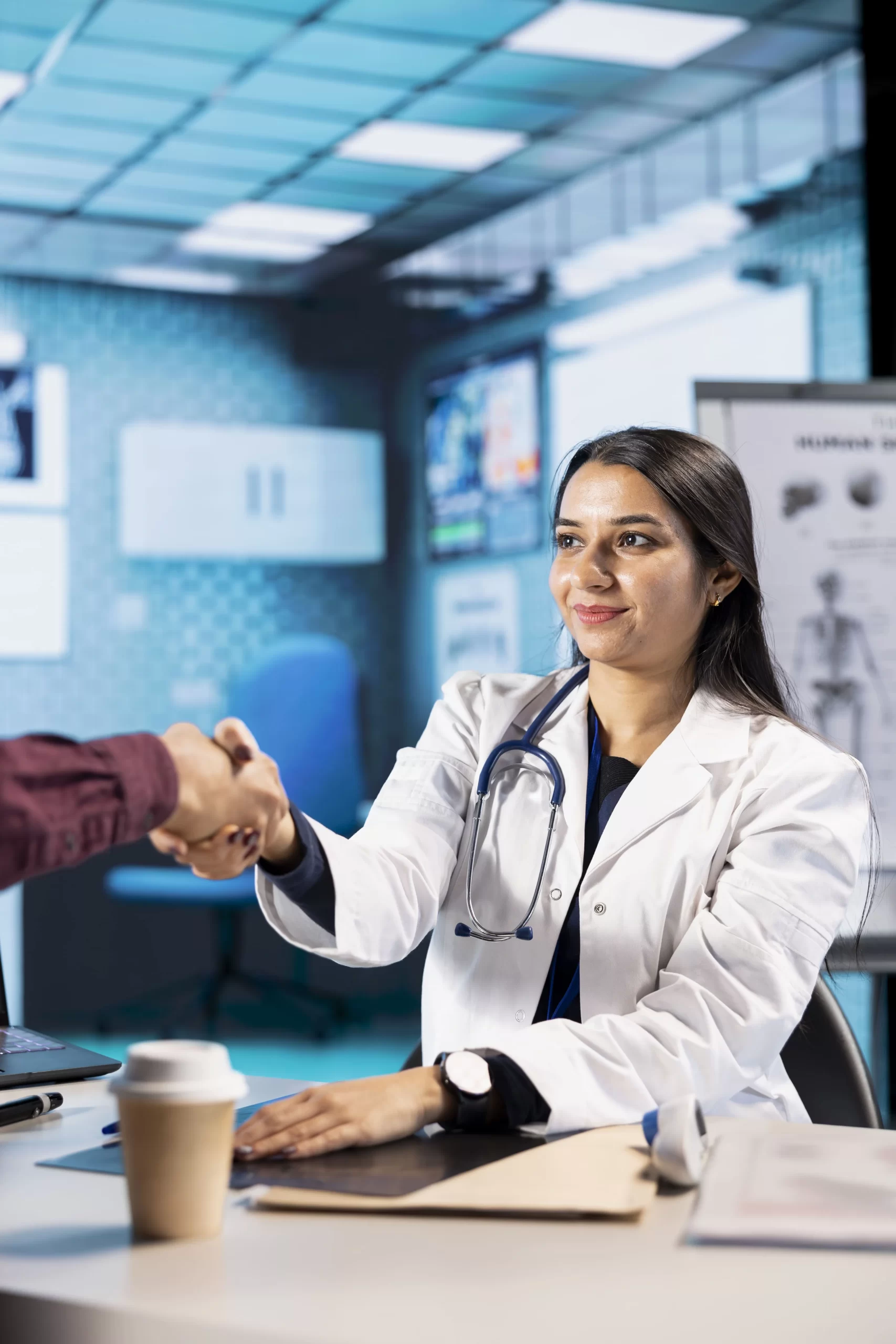 female-specialist-welcoming-her-indian-male-patient-check-up-visit